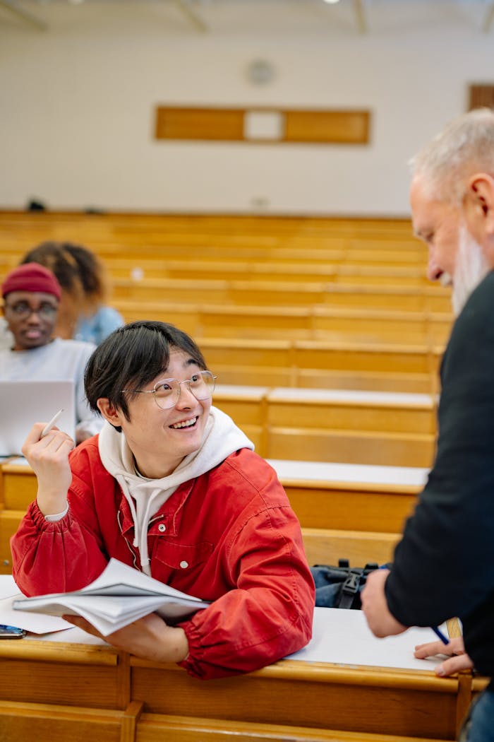 A student engaging with a professor in a university lecture hall, showcasing interactive learning.